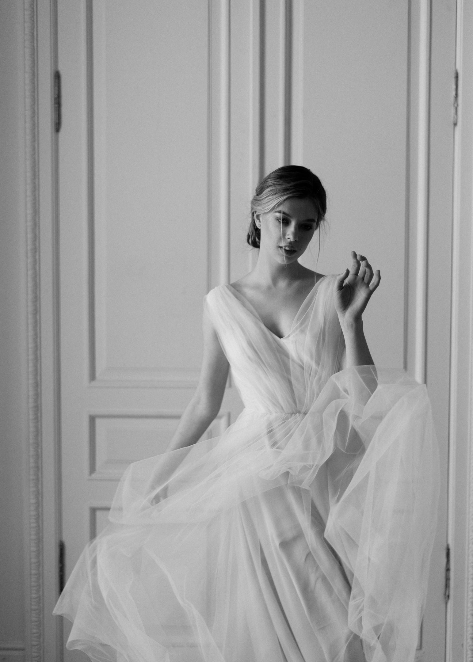 Bride seated in Peony tulle wedding dress, black and white