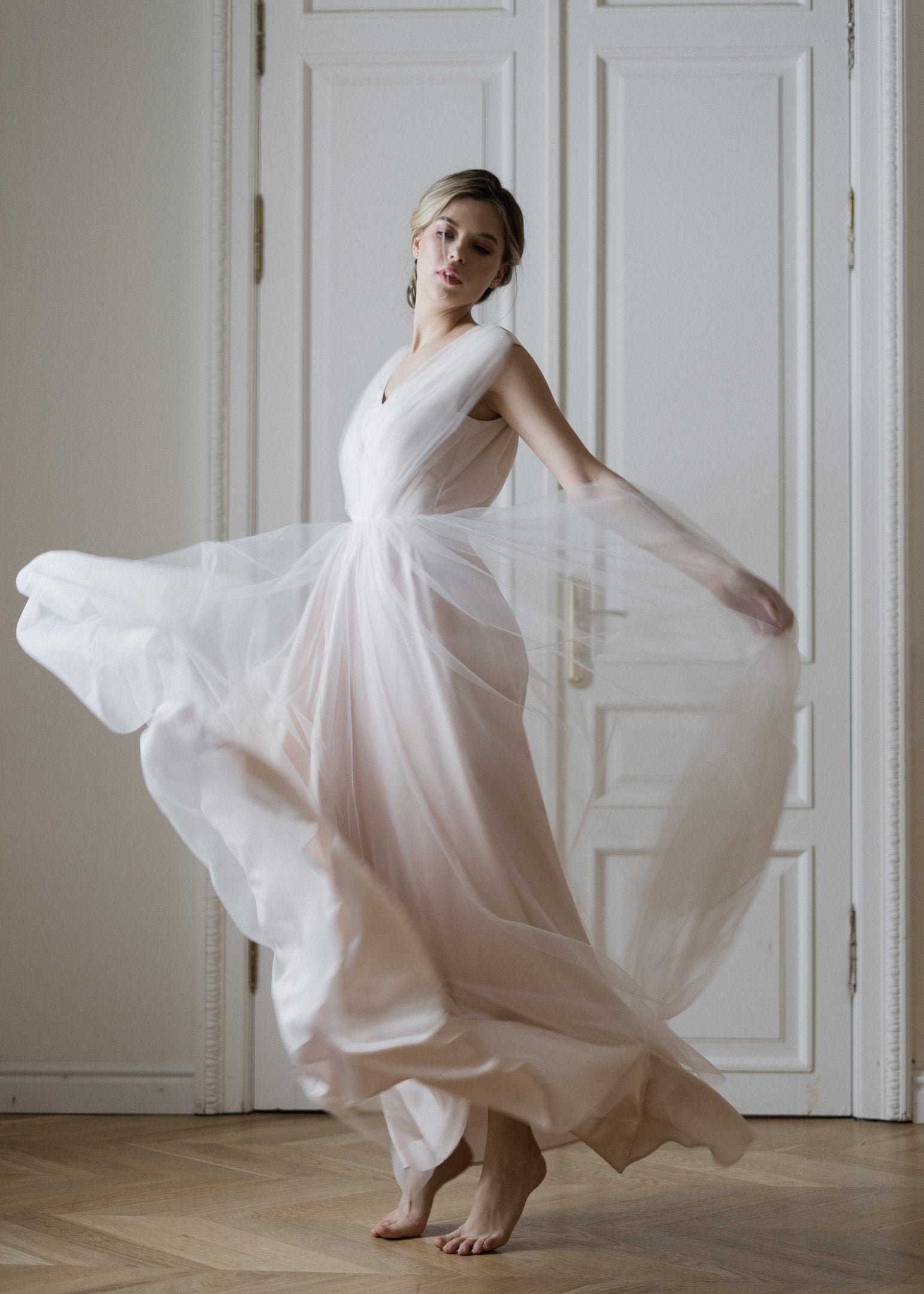 Bride twirling in Peony wedding dress, showing the flowing tulle skirt