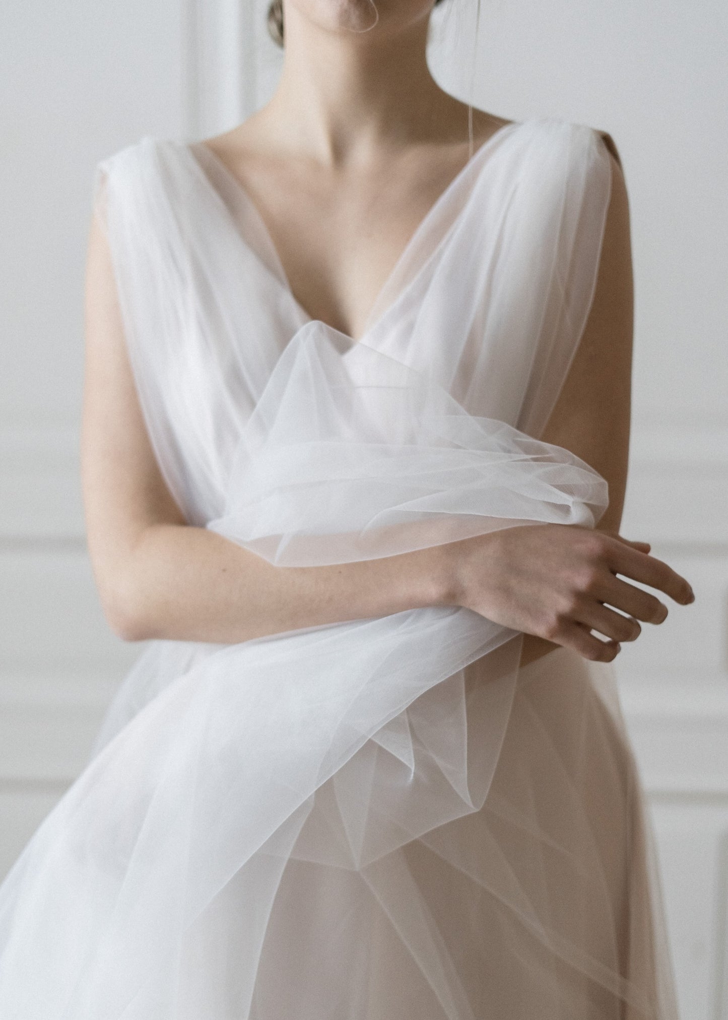 Close-up of Peony blush tulle wedding dress with V-neckline and gathered waist