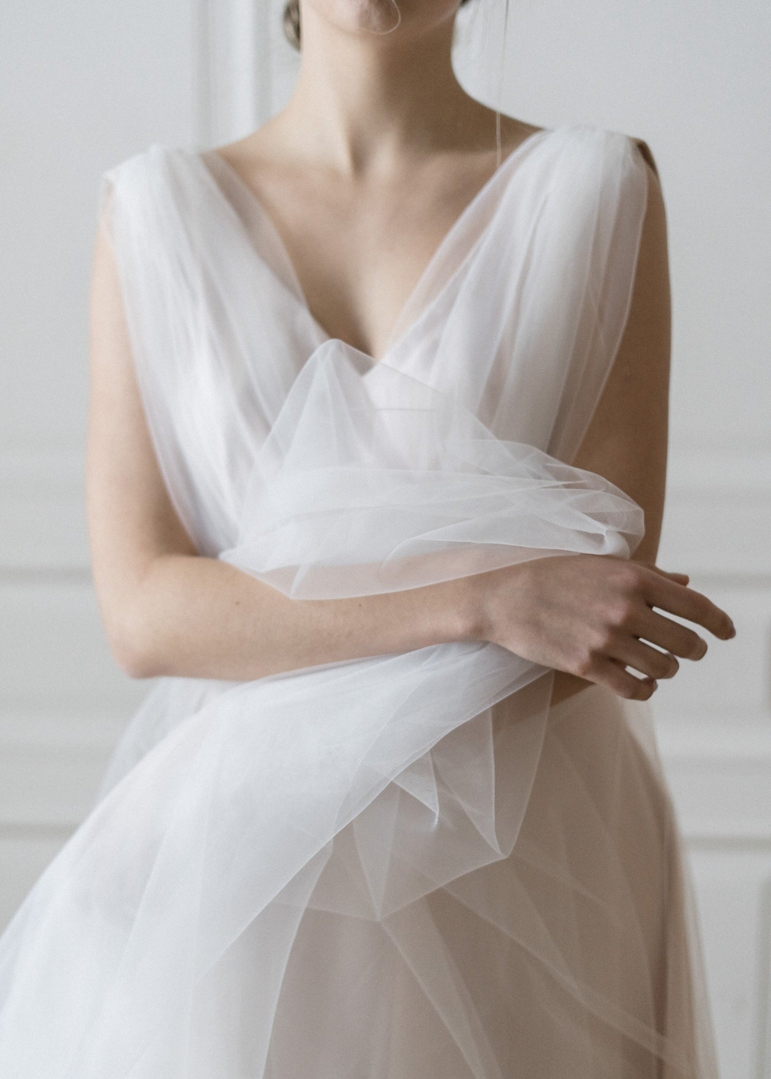 Close-up of Peony blush tulle wedding dress with V-neckline and gathered waist