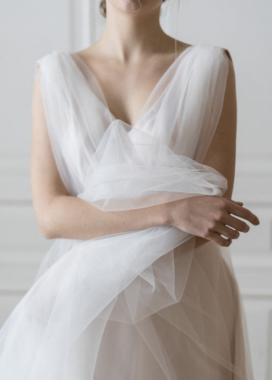 Close-up of Peony blush tulle wedding dress with V-neckline and gathered waist