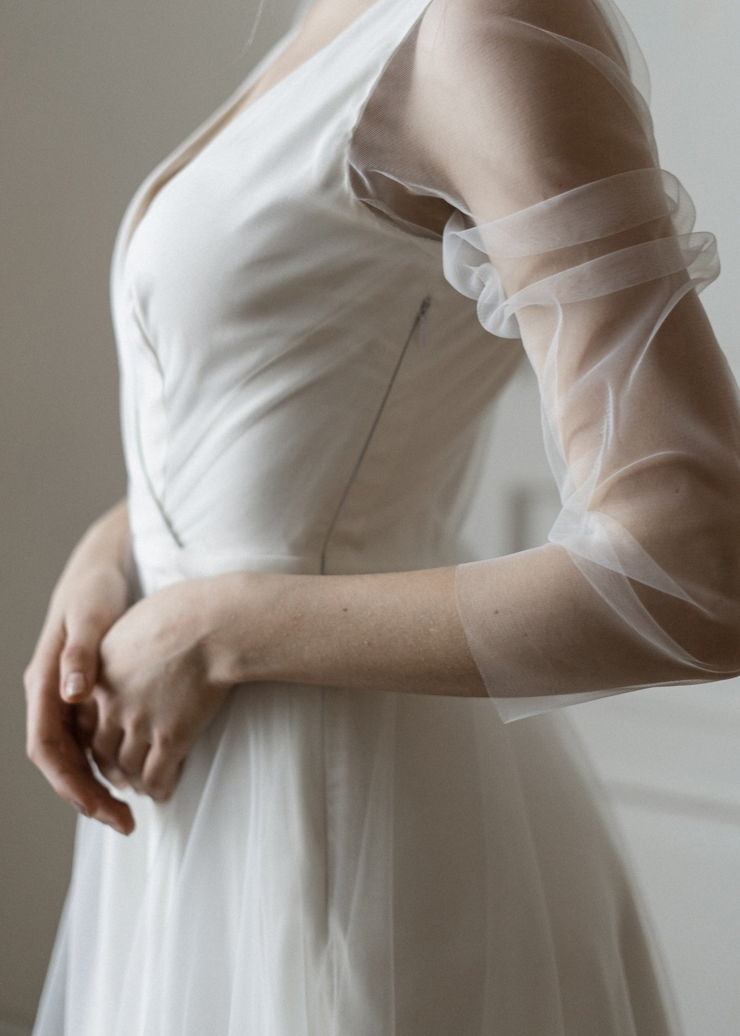Side detail of Tulipa's satin bodice and sheer tulle sleeve