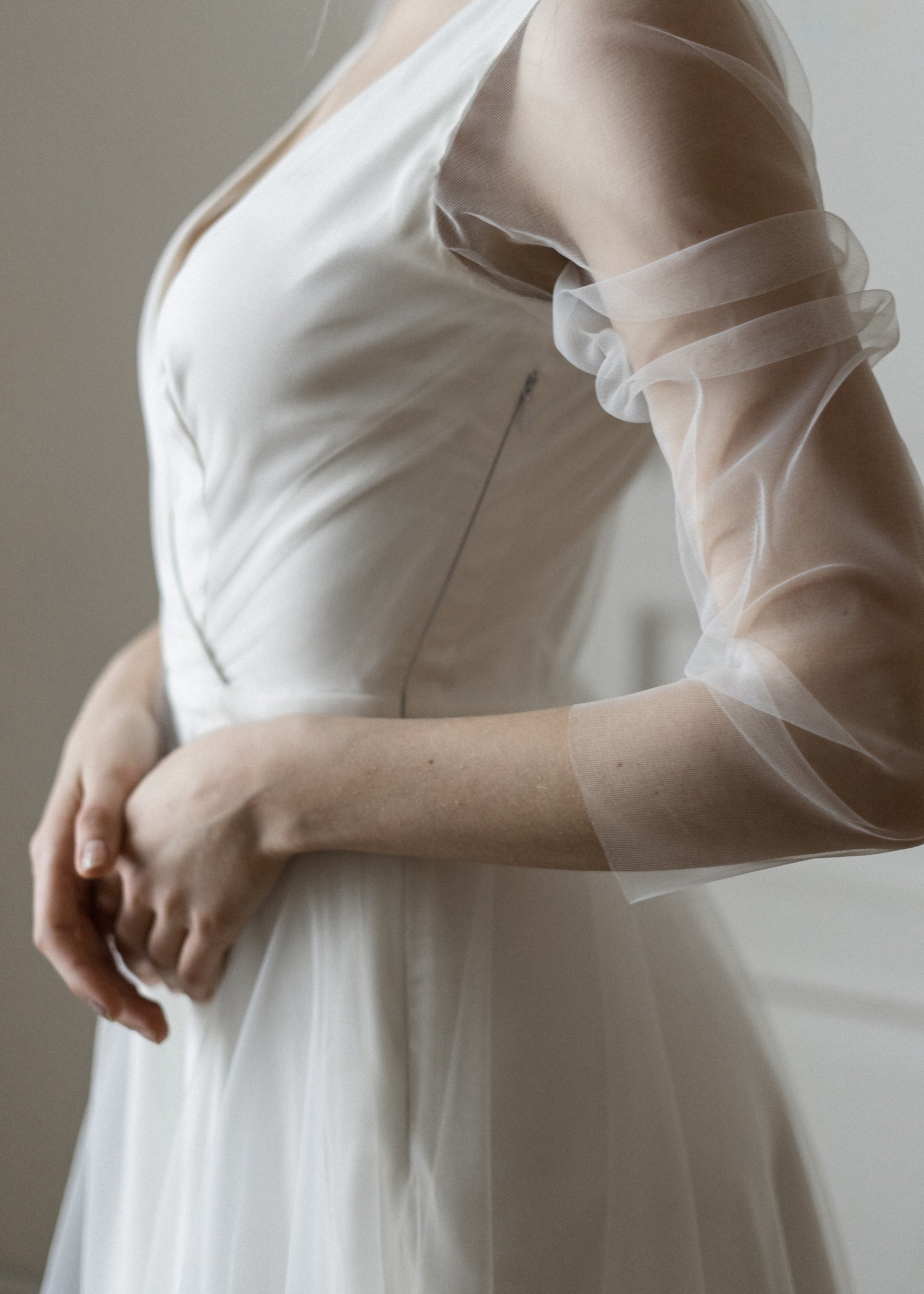Side detail of Tulipa's satin bodice and sheer tulle sleeve