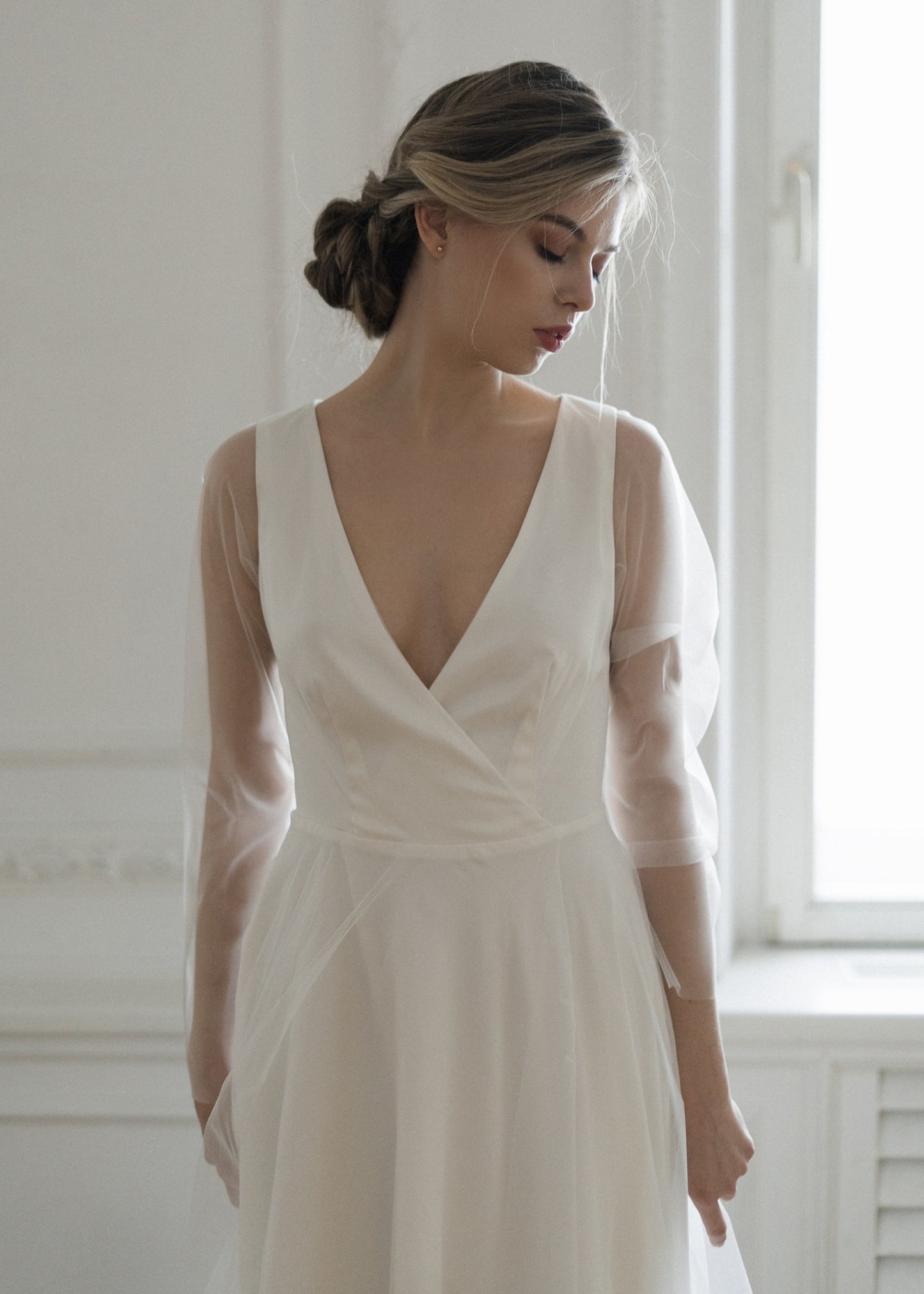 Bride in Tulipa satin wedding dress with tulle long sleeves, front view