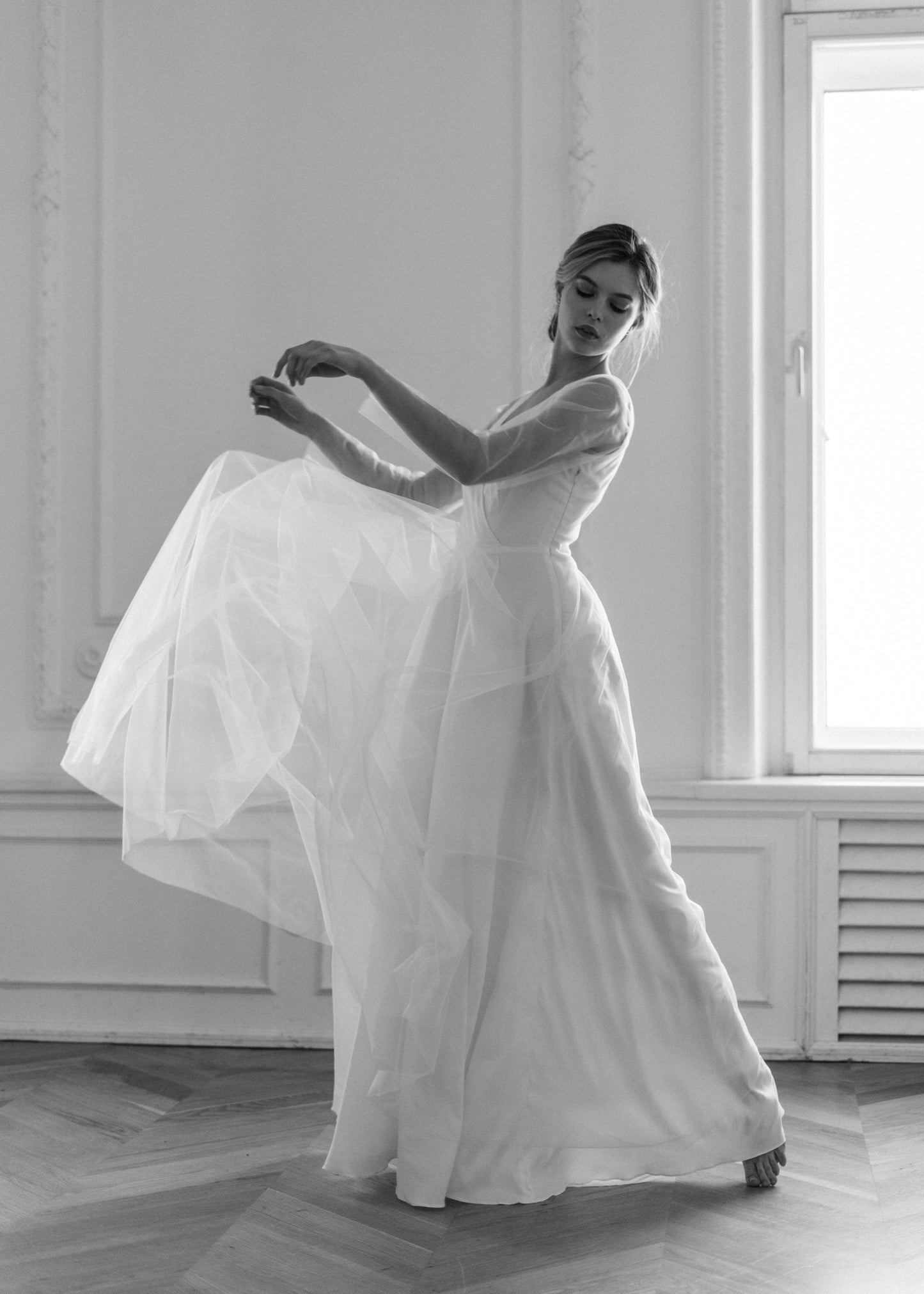 Bride moving in Tulipa wedding dress, showing the flowing tulle skirt