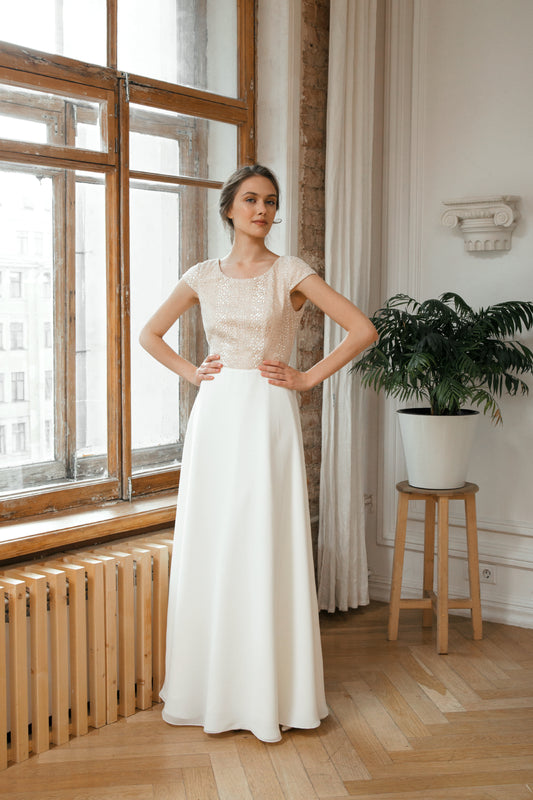 Una wedding dress, front view with champagne sequinned bodice and white A-line skirt
