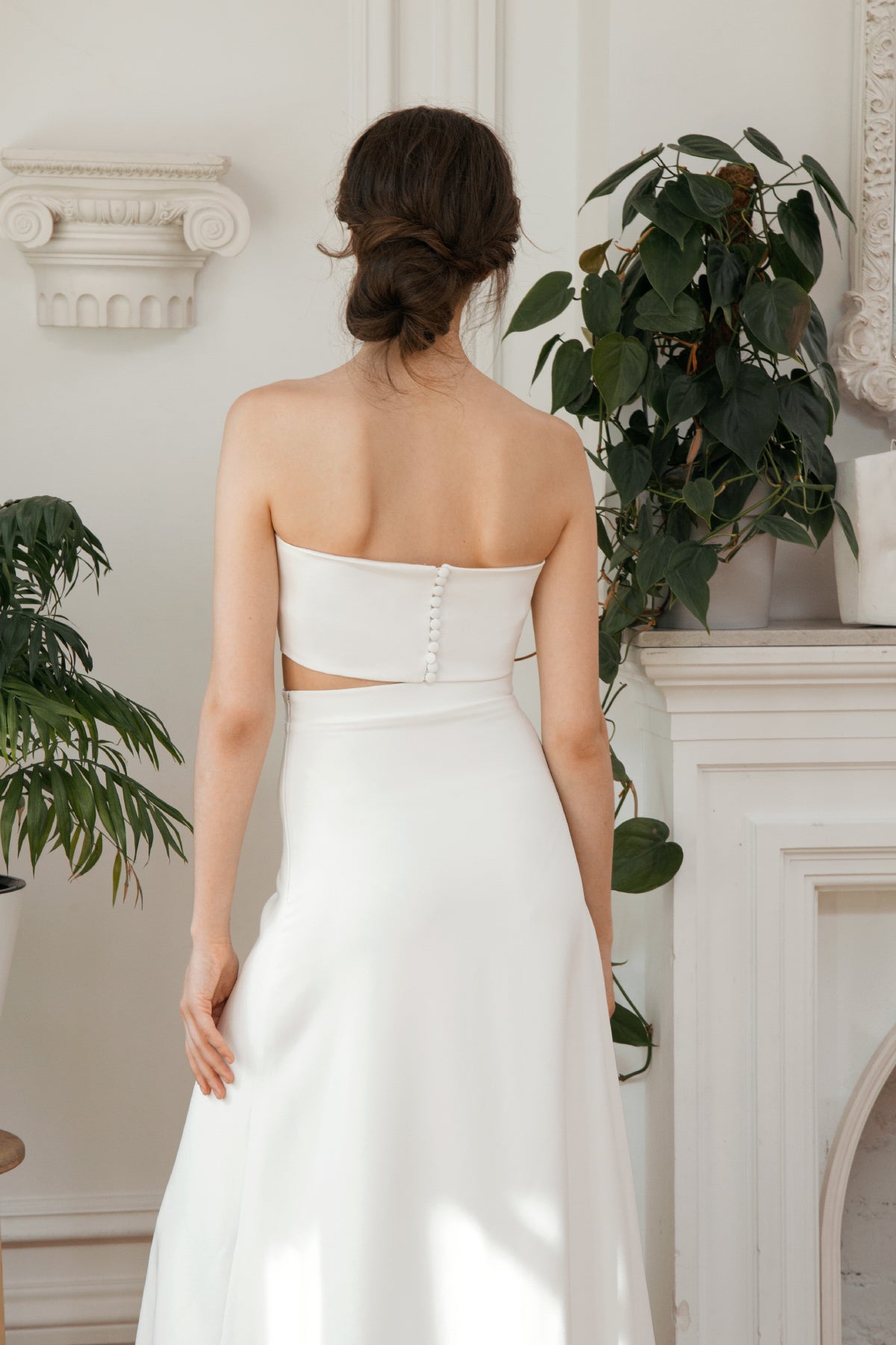 Covered-button back detail on a strapless bridal crop top