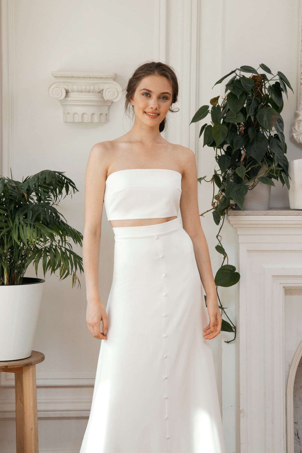 Strapless crop top and high-waisted button skirt on a two-piece wedding dress