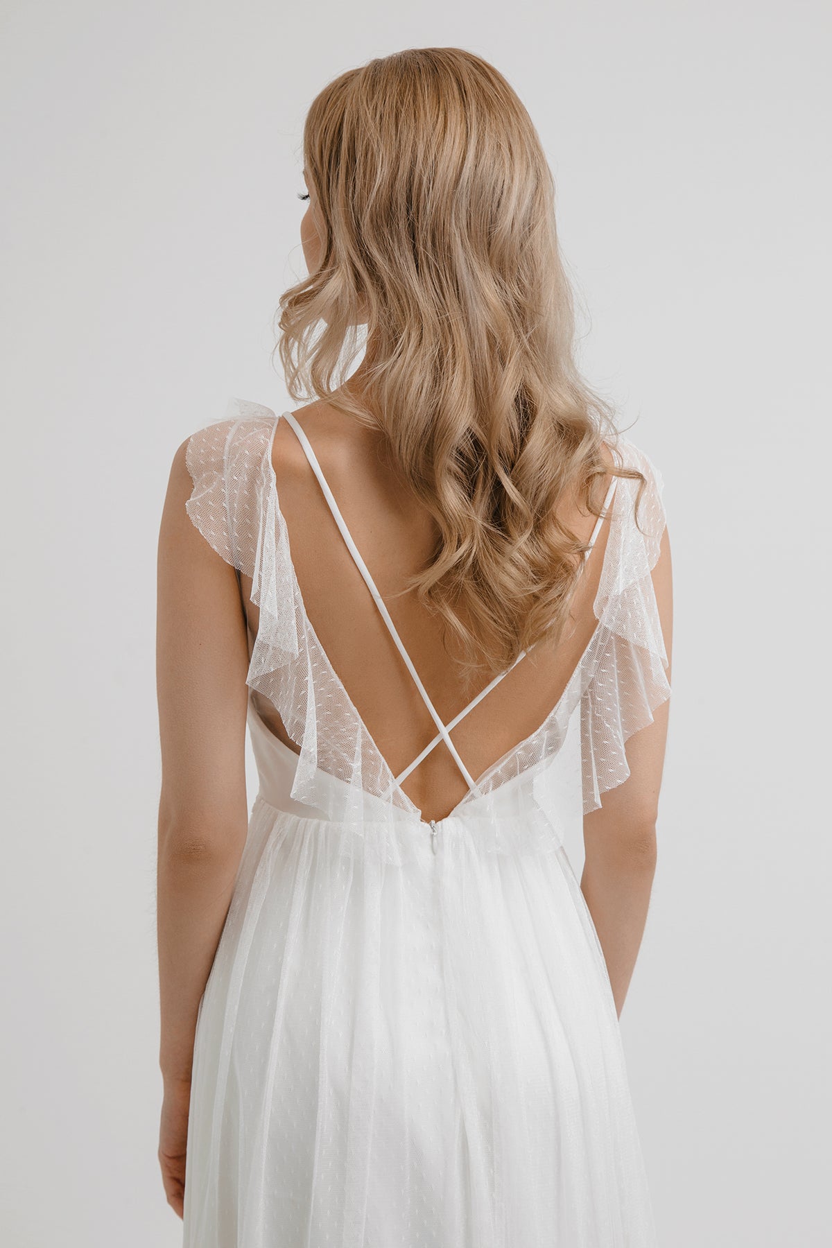 Back view of Whisper of the Wind wedding dress with deep V back and crossed straps