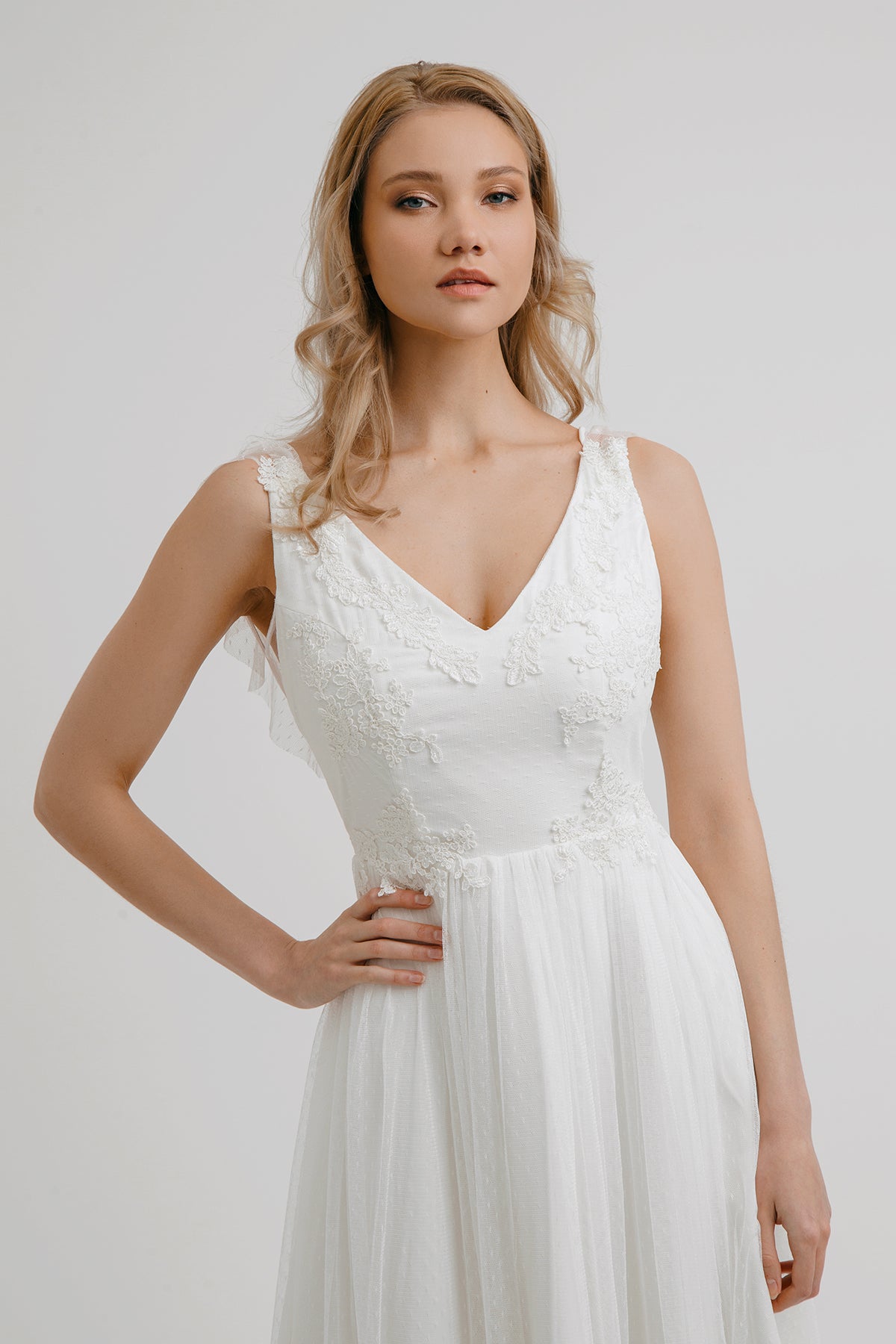 Front detail of Whisper of the Wind dress showing lace appliqué and flutter shoulders